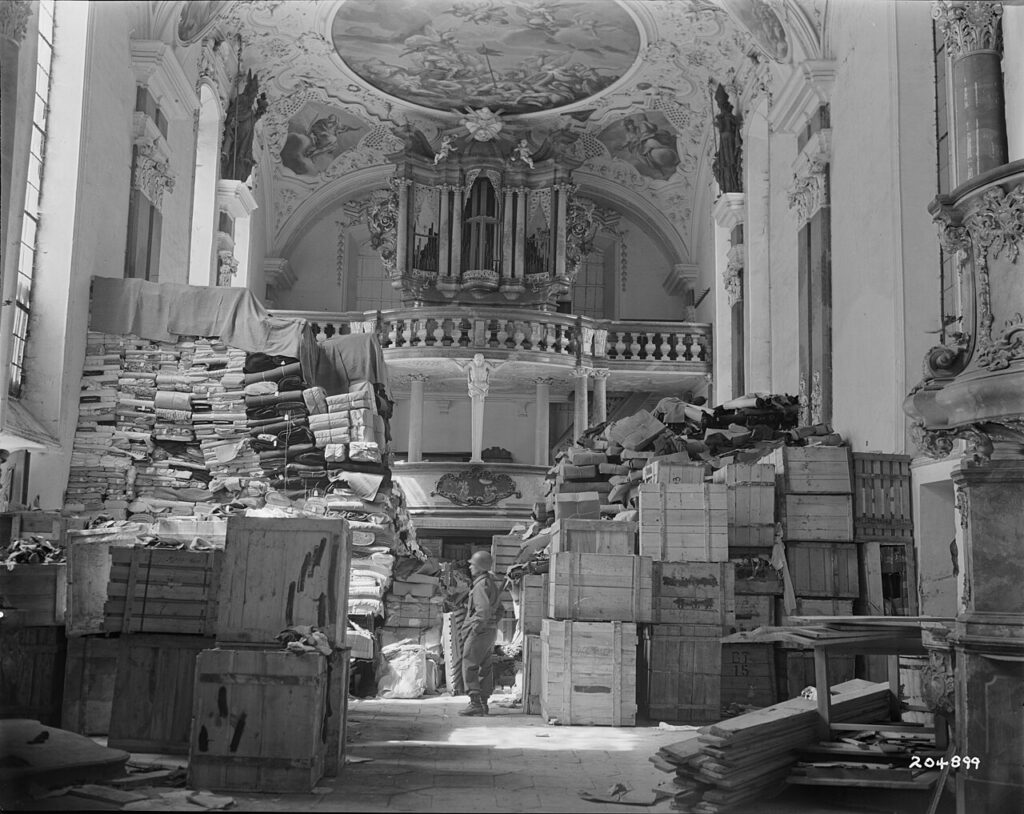 An American 3rd Army soldier inspects German loot stored, found at the Schloßkirche in the south German town Ellingen, April 24, 1945