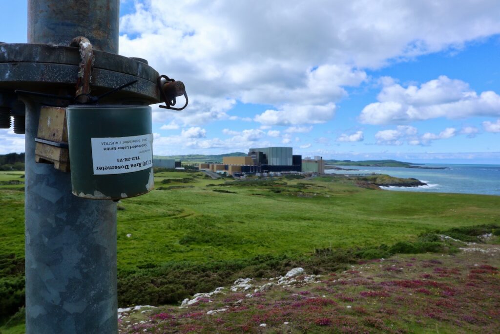 Dosimiter with Wylfa Power Station in the background